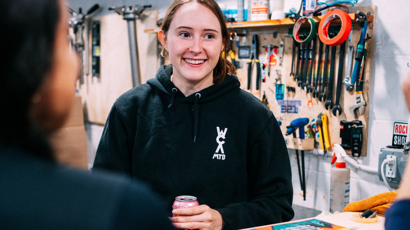 Person in a workshop setting with tools and equipment in the background