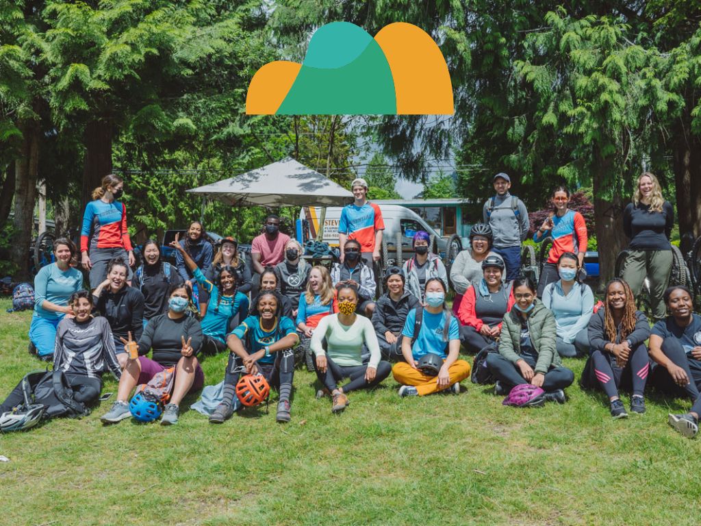 Group of people sitting on grass with a CTT logo above them
